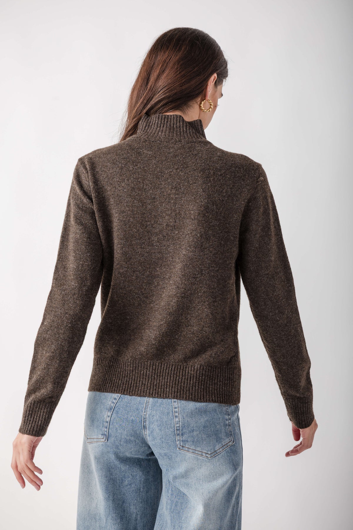 Brown mock neck cardigan with ribbed trim, shown from back view on model wearing blue jeans.
