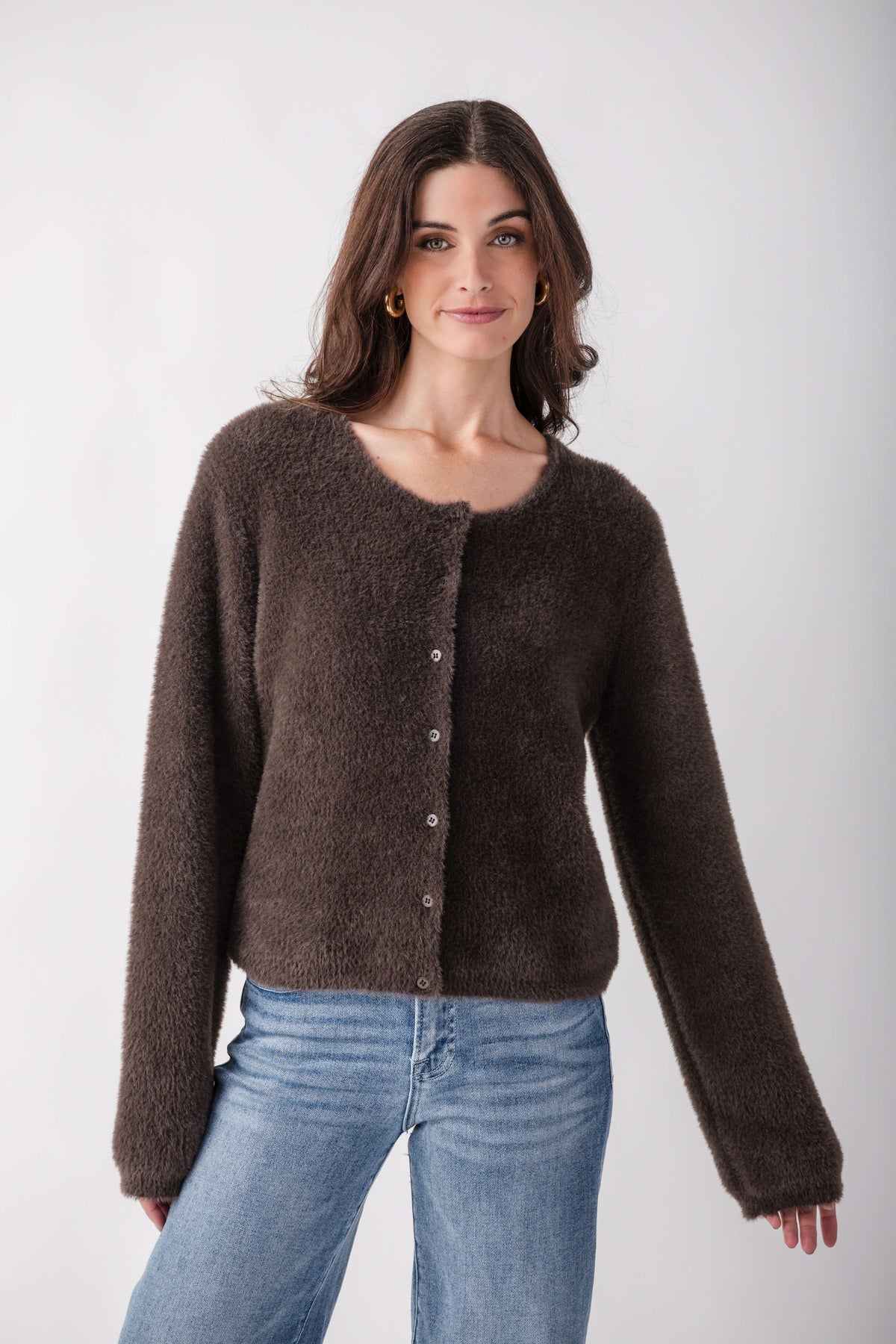 Charcoal gray fluffy cardigan with button front and V-neckline worn over blue jeans.