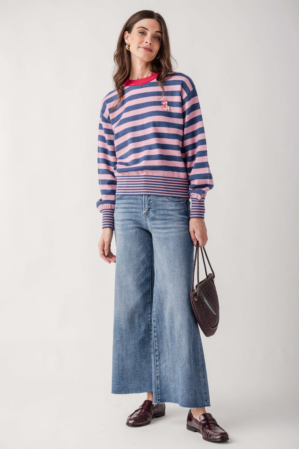 Navy and pink striped sweater with small embroidered dog graphic on chest and ribbed cuffs.