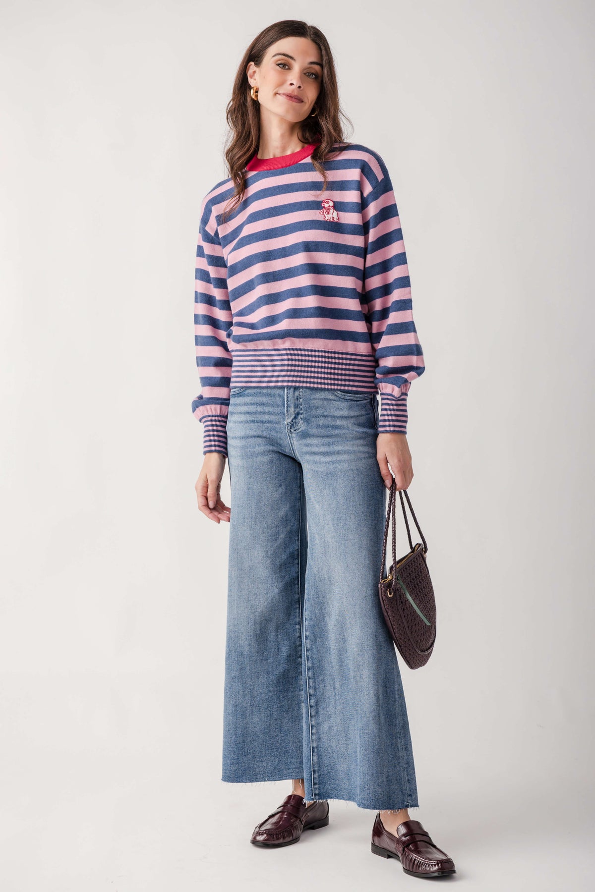 Navy and pink striped sweater with small embroidered dog graphic on chest and ribbed cuffs.