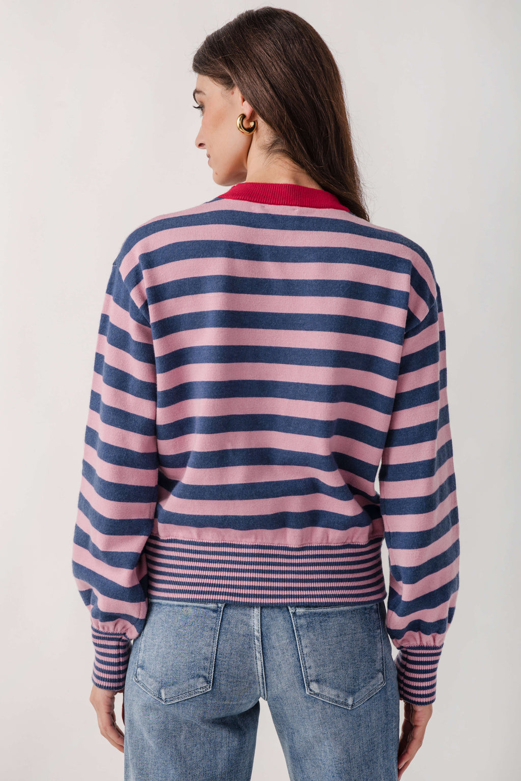 Pink and navy horizontal striped crew neck sweater with red ribbed collar and striped ribbed cuffs.