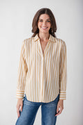 Tan and white striped button-up shirt with long sleeves and pointed collar, worn with blue jeans.