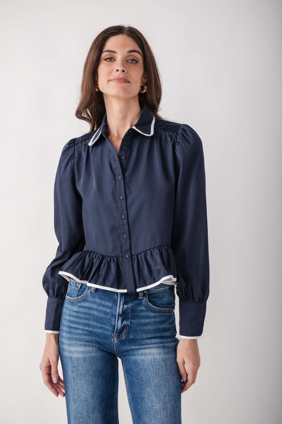 Navy blue button-up top with Peter Pan collar, white trim, puffed sleeves, and gathered waist detail.