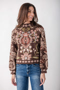 Brown sweater with red, cream, and olive floral and geometric print, scalloped hem, long sleeves.