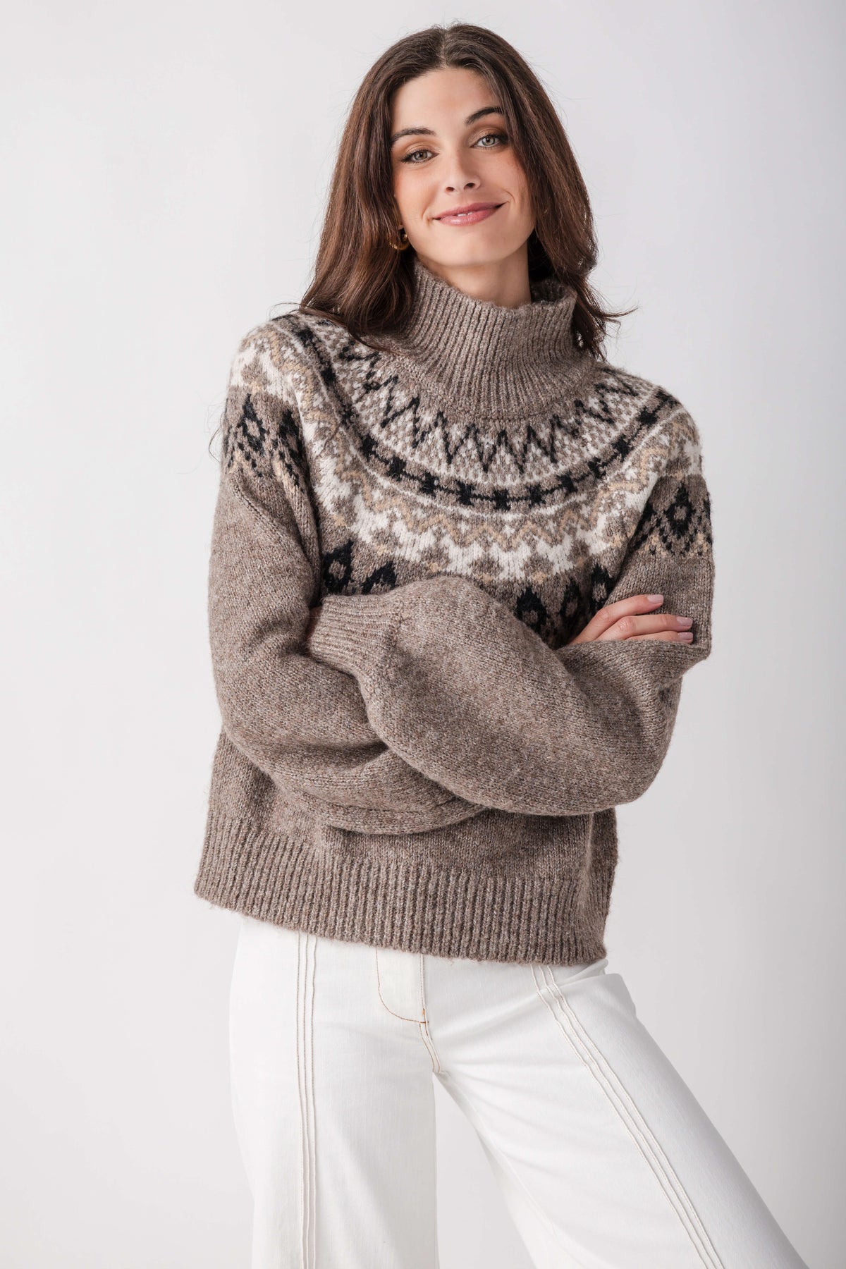 Gray turtleneck sweater with black and cream geometric pattern across chest and shoulders.