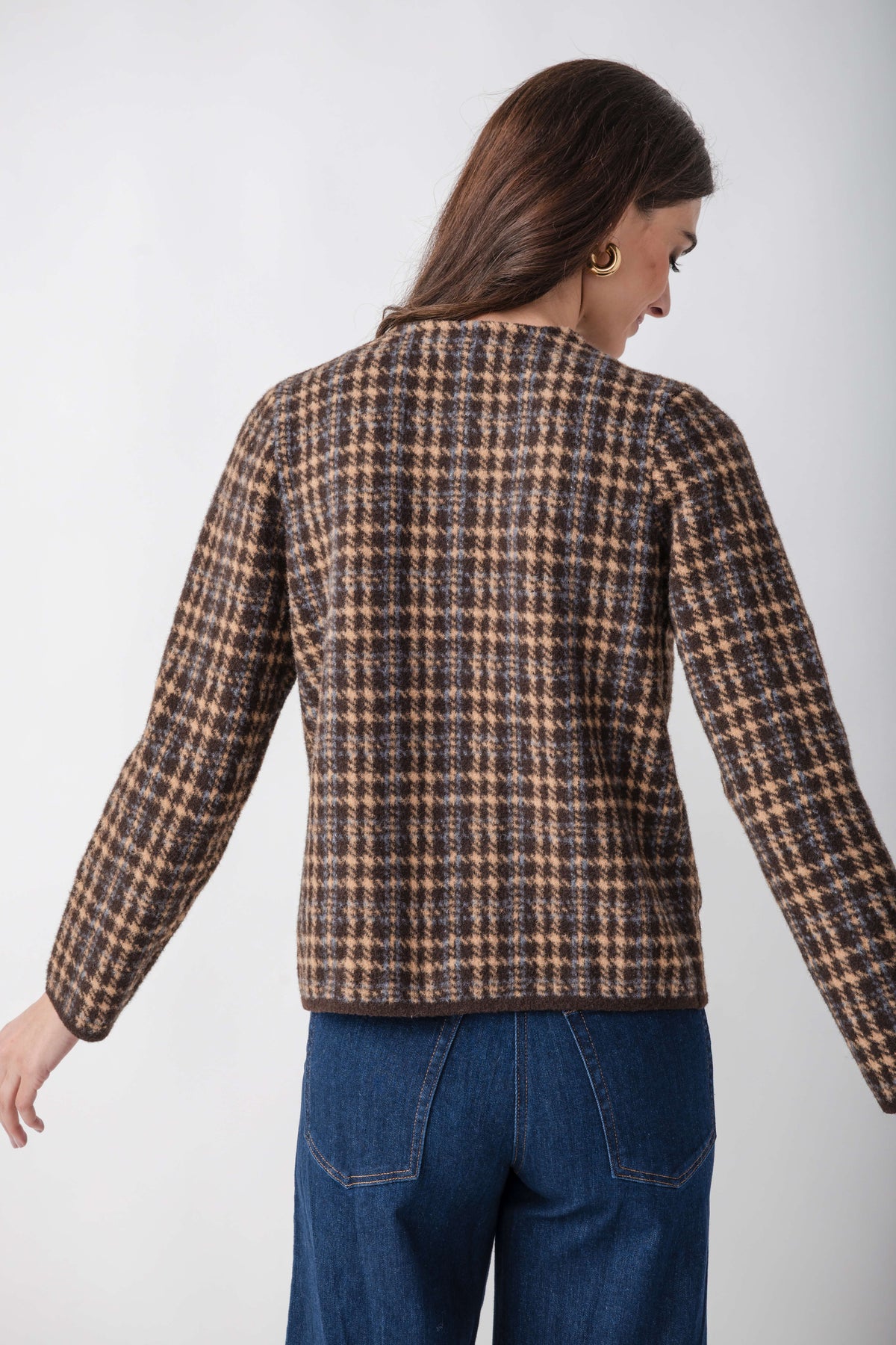 Brown and tan houndstooth tweed jacket with long sleeves, shown from back view on model wearing blue jeans.