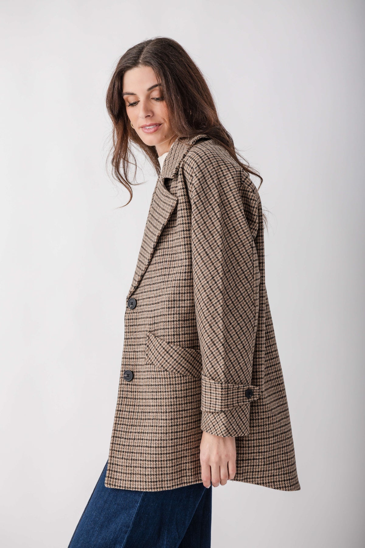 Brown and cream houndstooth pea jacket with notched collar, button front, and flap pockets.