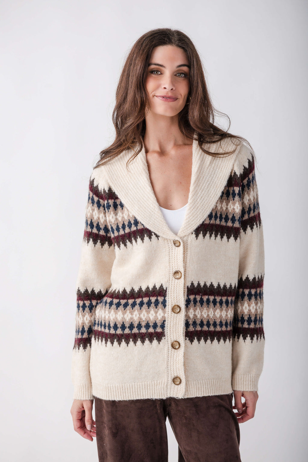 Cream cardigan with navy, burgundy, and tan geometric patterning on sleeves and torso, button front, and collared neckline.