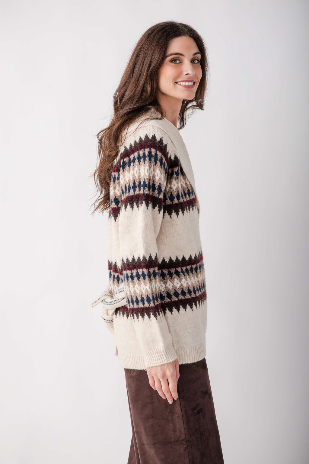 Cream cardigan with navy, burgundy, and black geometric pattern across shoulders and sleeves.