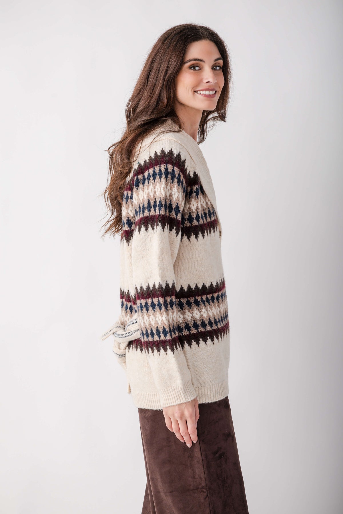 Cream cardigan with navy, burgundy, and black geometric pattern across shoulders and sleeves.