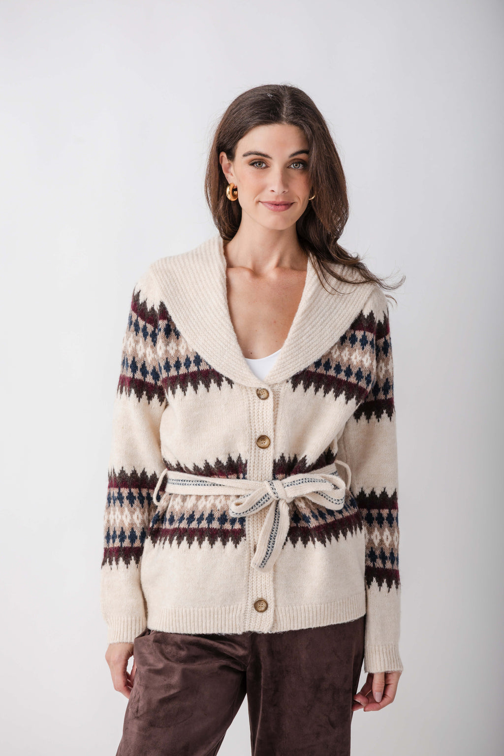 Cream cardigan with navy, burgundy, and tan geometric patterns on sleeves, shawl collar, button front, and tie waist.