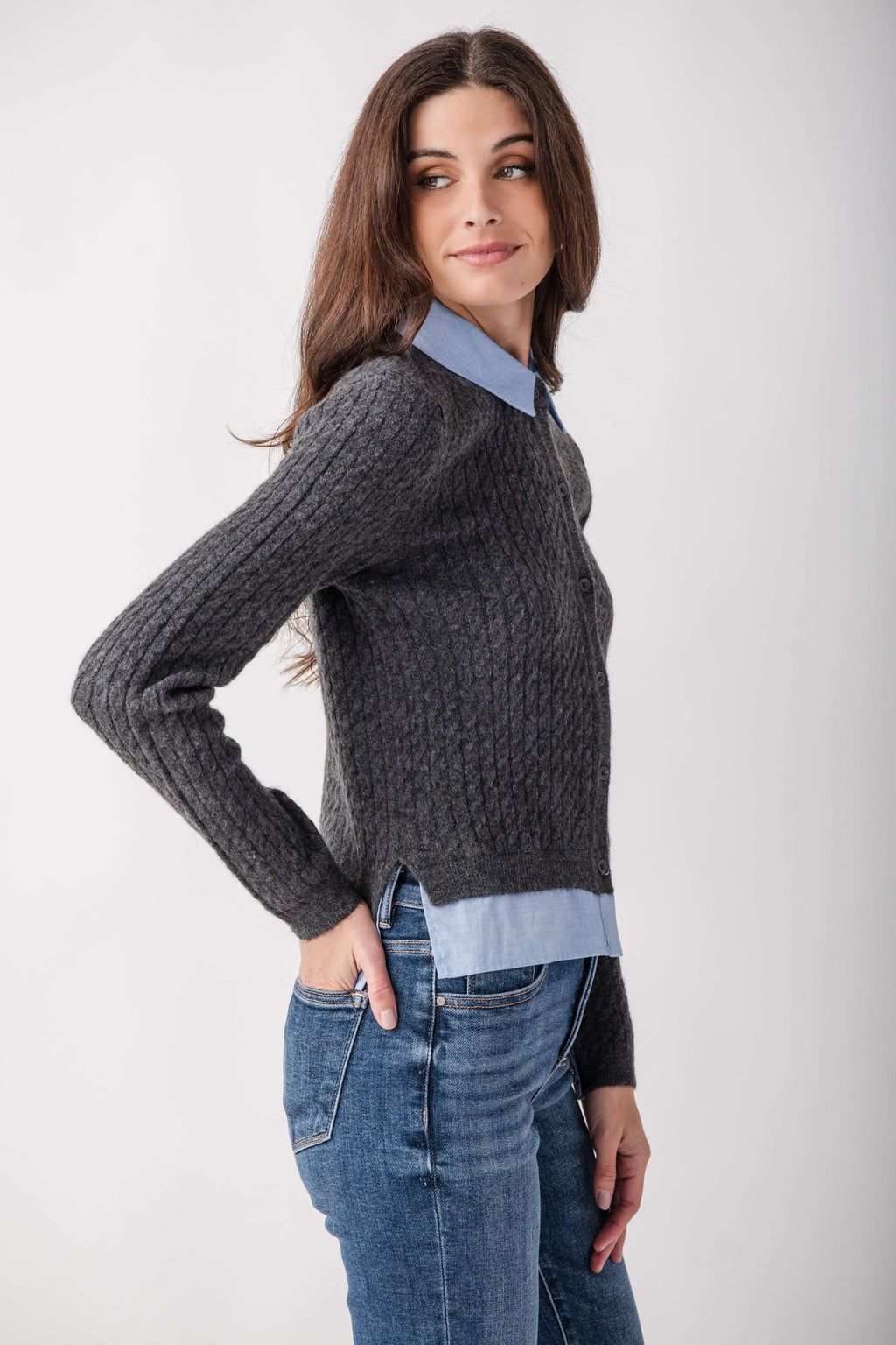 Charcoal ribbed knit top with blue chambray collar and hem details, worn with blue jeans.