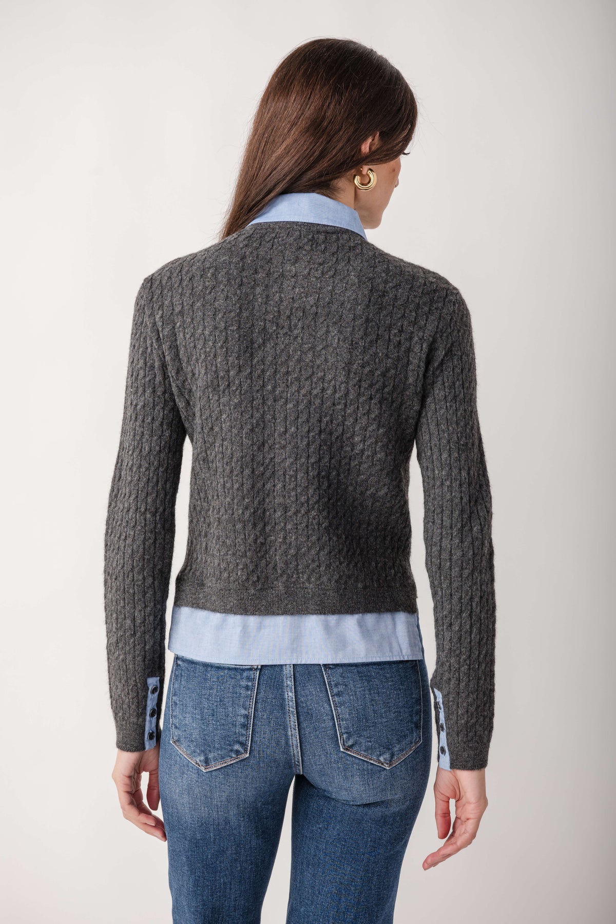 Charcoal ribbed knit top with light blue collar and hem, worn with jeans.