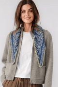 Denim blue knitted triangle scarf with ornate border trim